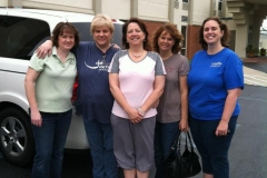 5-moms-on-a-conference-trip-posing-by-their-van