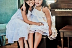 sisters-pose-in-front-of-piano-photo-image-photography