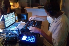 teen-boy-with-autism-works-at-desk-full-of-computer-equipment