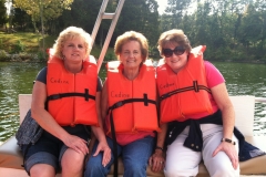 three-caregiver-friends-riding-boat-on-a-retreat
