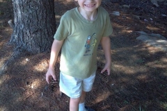 young-boy-standing-by-tree