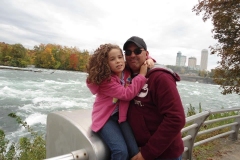 young-girl-hugging-dad-in-front-of-Niagara-Falls
