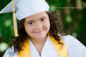 child with Down Syndrome dressed to graduate from kindergarten