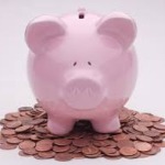 Piggy Bank sitting on top of pile of pennies