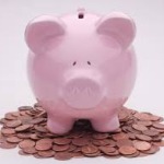 Piggy Bank sitting on top of pile of pennies